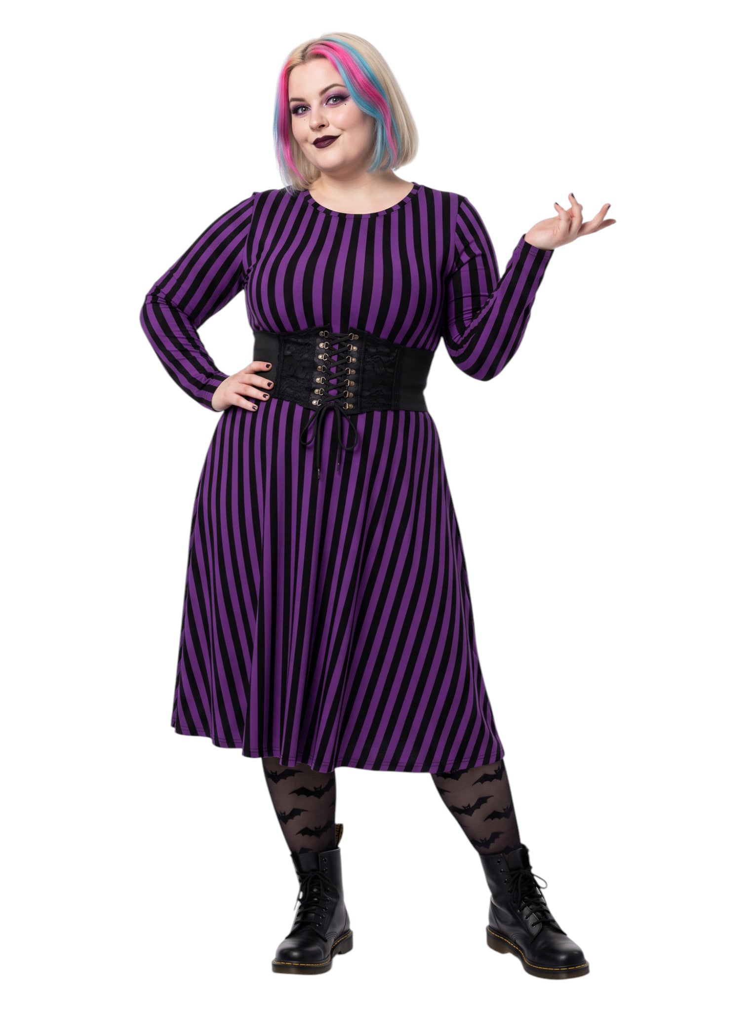 Plus size woman modeling gothic purple and black vertically striped long sleeve fit and flare midi dress with side pockets