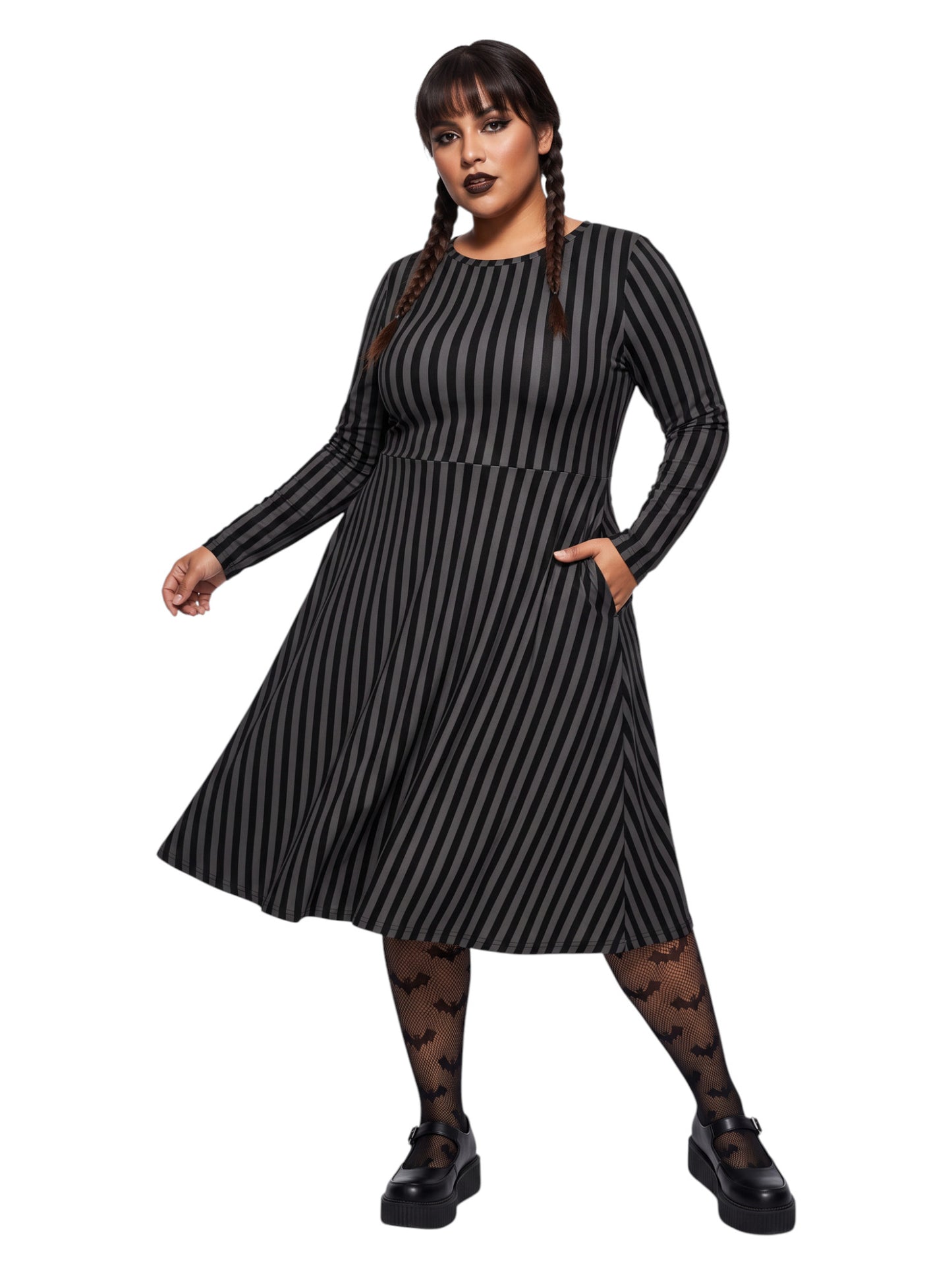 Plus size woman wearing a gothic grey and black vertically striped fit and flare midi dress with long sleeves, functional side pockets, and a scoop neckline.