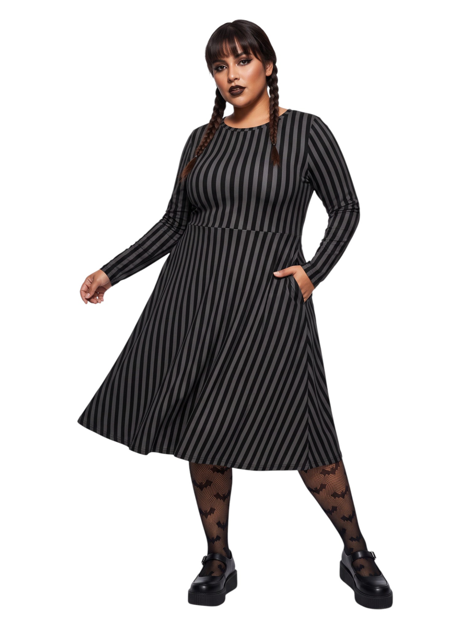 Plus size woman wearing a gothic grey and black vertically striped fit and flare midi dress with long sleeves, functional side pockets, and a scoop neckline.
