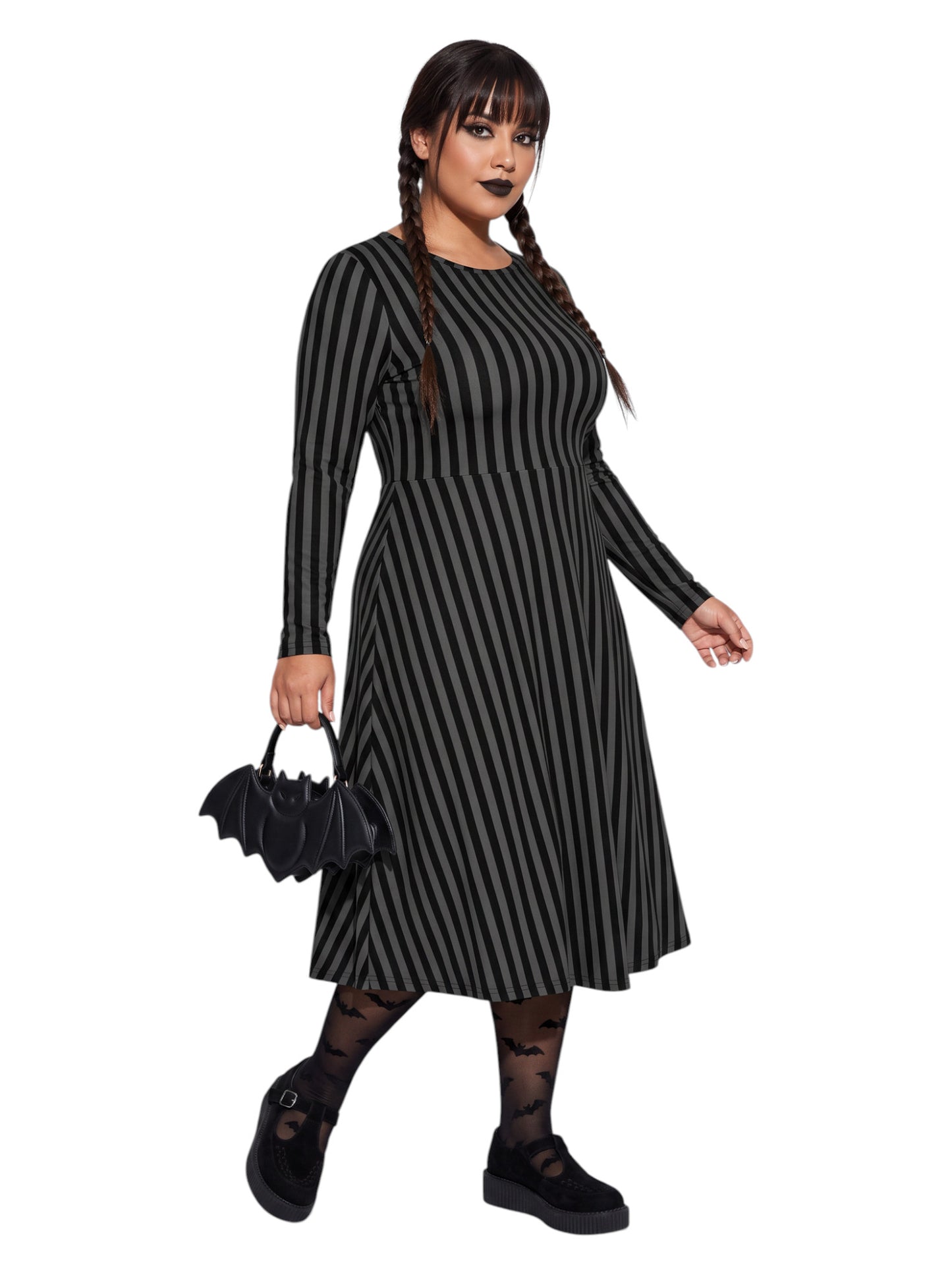 Plus size woman wearing a gothic grey and black vertically striped fit and flare midi dress with long sleeves, functional side pockets, and a scoop neckline.