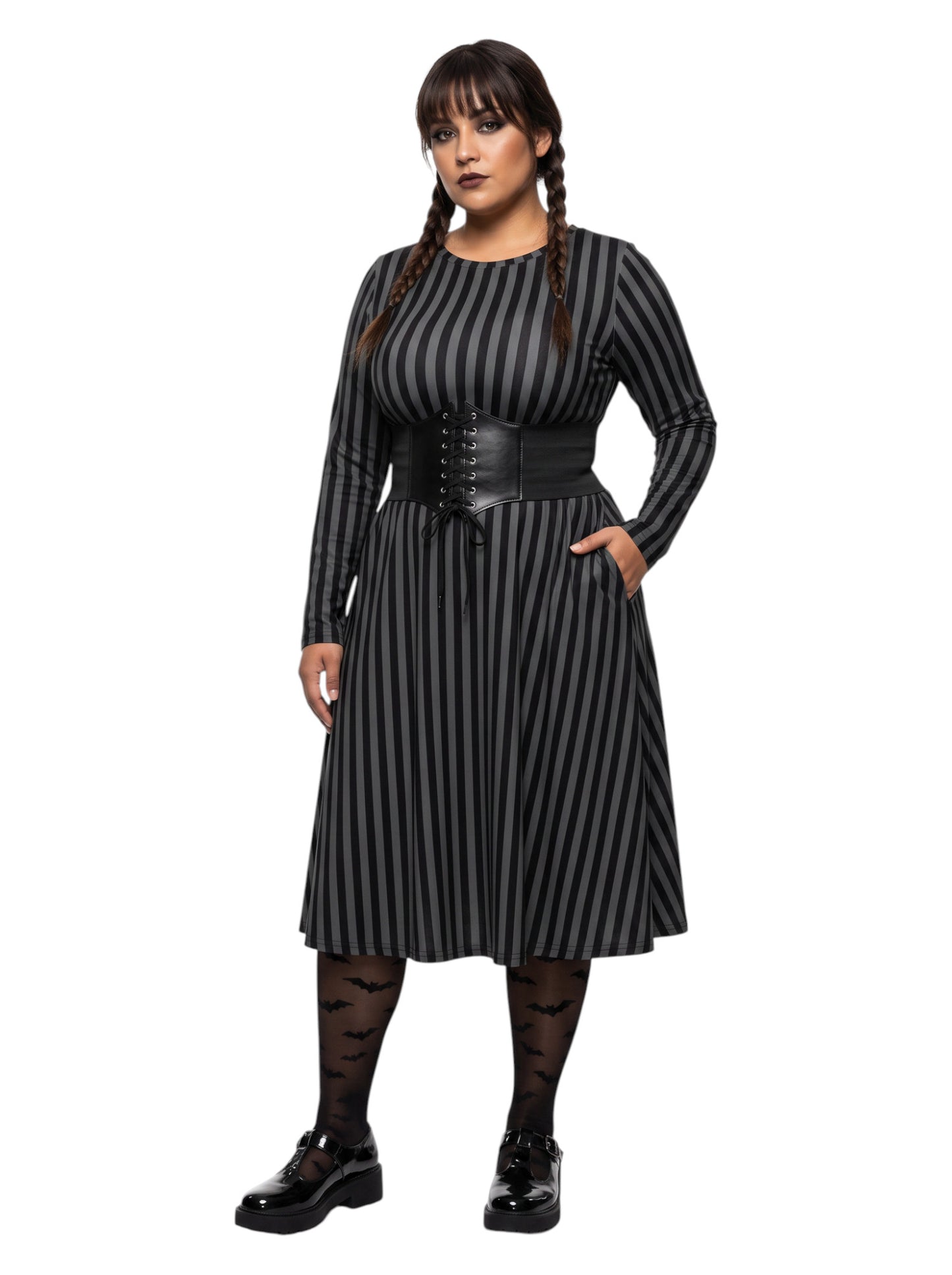 Plus size woman wearing a gothic grey and black vertically striped fit and flare midi dress with long sleeves, functional side pockets, and a scoop neckline.