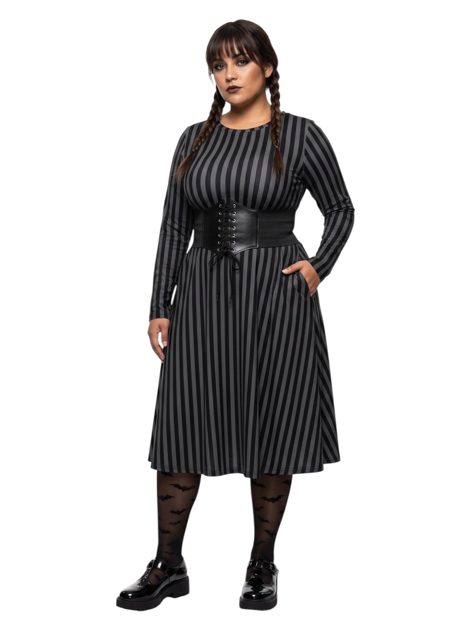 Plus size woman wearing a gothic grey and black vertically striped fit and flare midi dress with long sleeves, functional side pockets, and a scoop neckline.