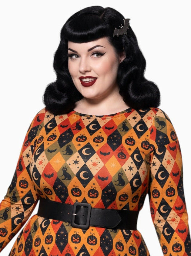 Woman wearing 1950s vintage halloween long sleeve swing dress.