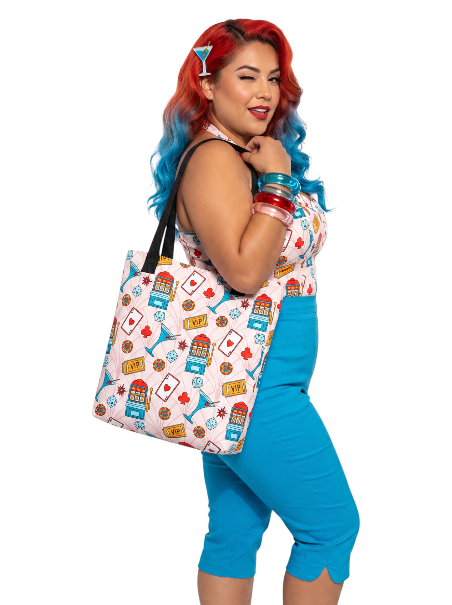 A woman wearing a martini Las Vegas Casino Pinup 1950s Rockabilly Tote Bag with retro slot machine and dice pattern.