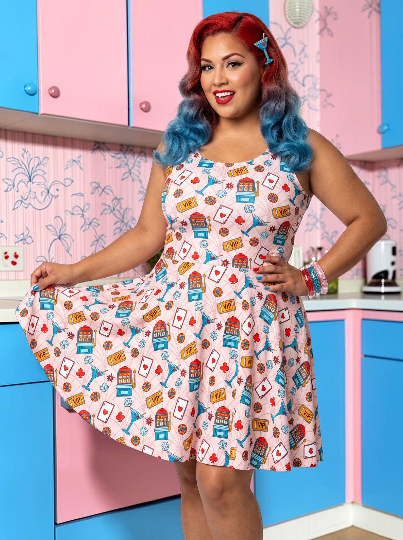 Plus-size model with red and blue hair wearing a pink retro casino print fit and flare dress featuring slot machines, playing cards, and blue martini glasses.
