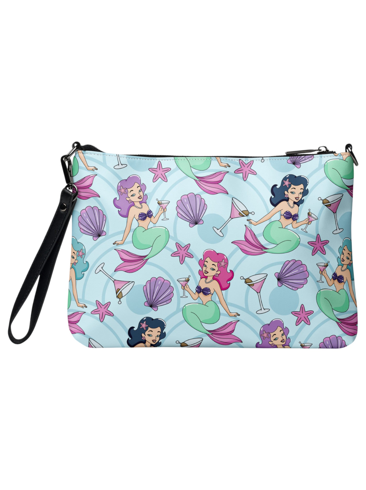 A woman wears as mermaids, martinis and seashells convertible clutch and crossbody bag in faux leather with adjustable strap.