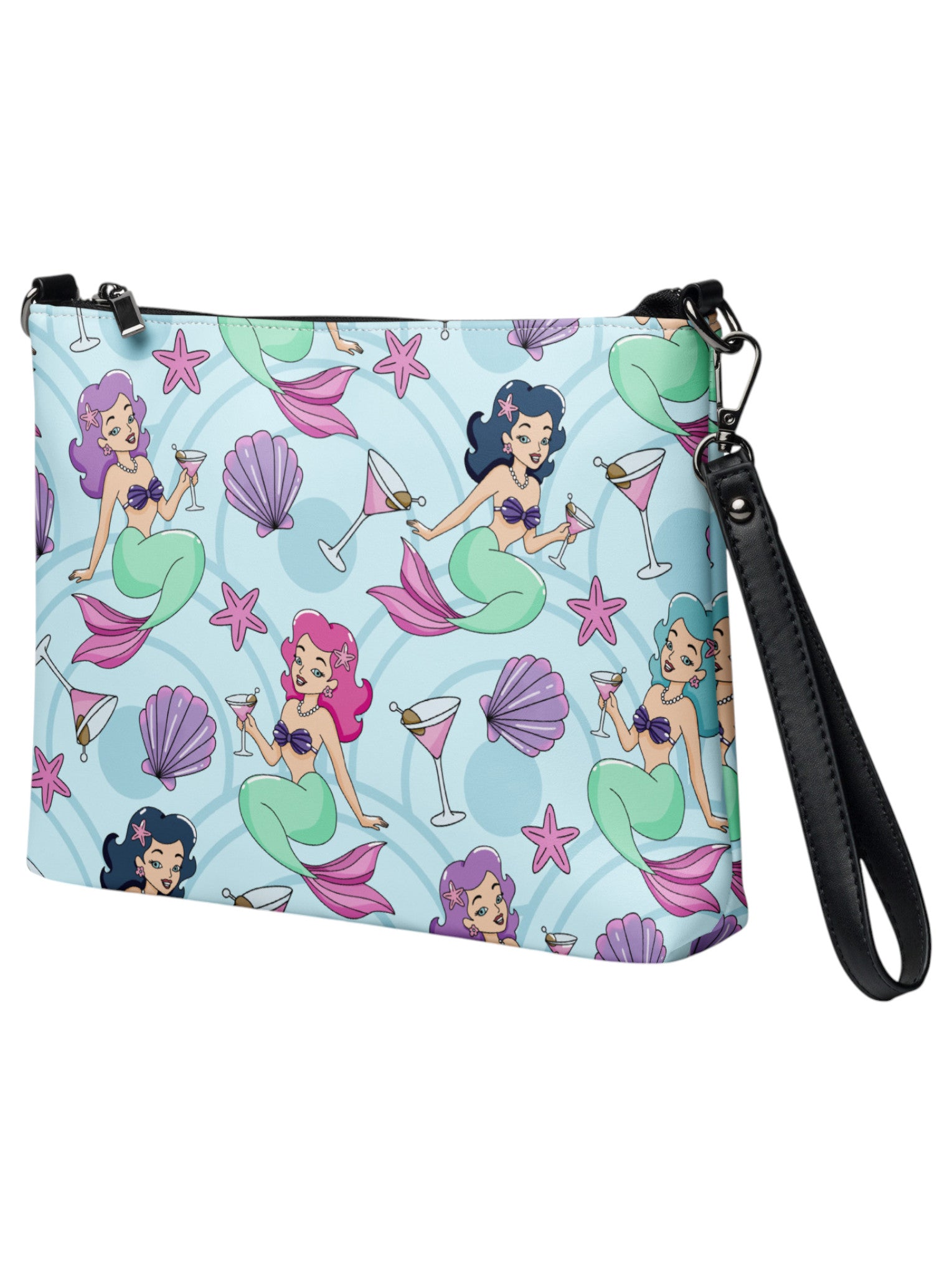 A woman wears as mermaids, martinis and seashells convertible clutch and crossbody bag in faux leather with adjustable strap.