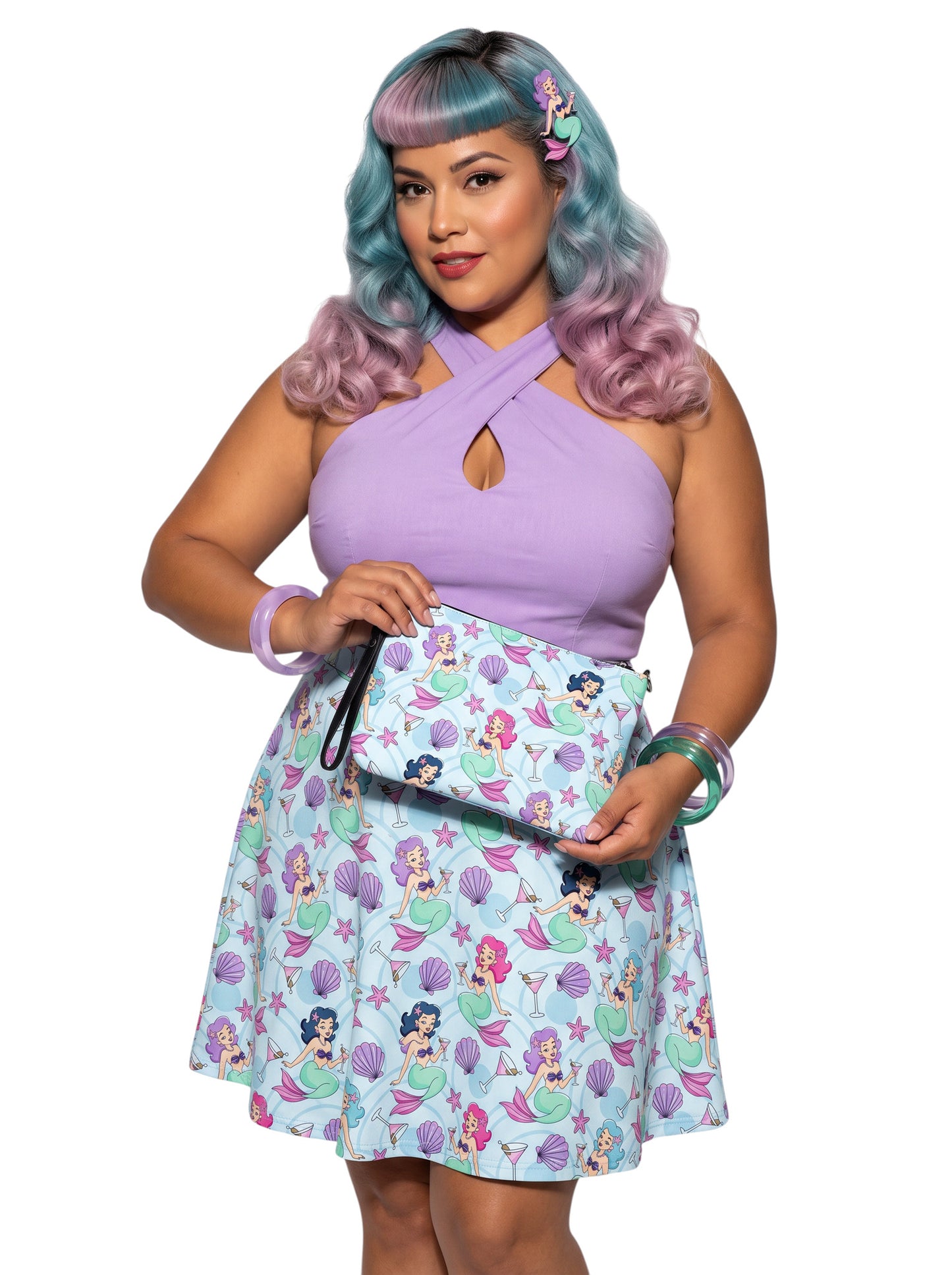 A woman wears as mermaids, martinis and seashells convertible clutch and crossbody bag in faux leather with adjustable strap.