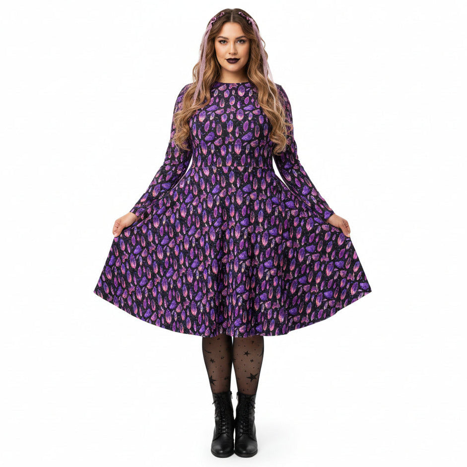 Woman wearing a purple patterned dress on a white background