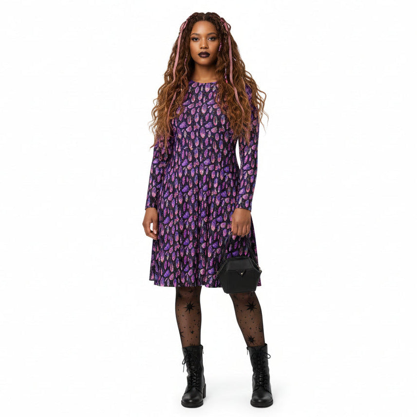 Woman wearing a purple patterned dress on a white background