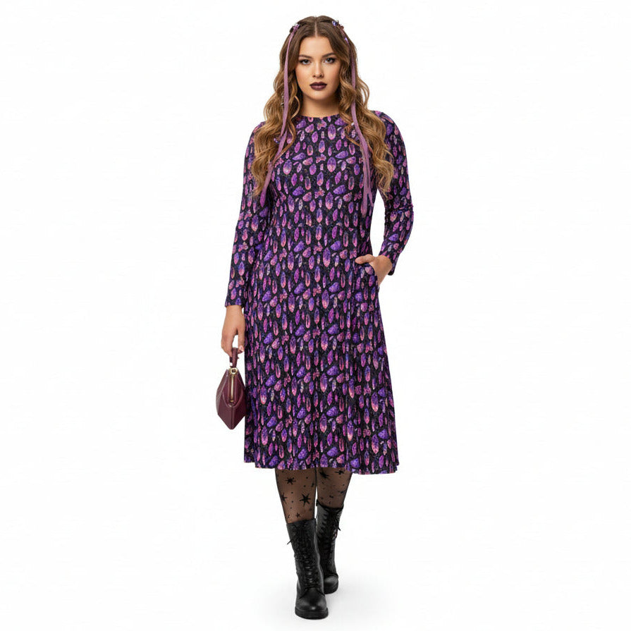 Woman wearing a purple crystal print  dress on a white background