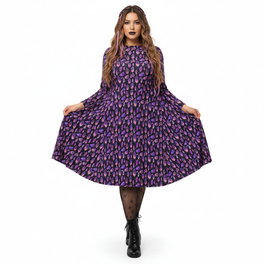 Woman wearing a purple crystal print  dress on a white background