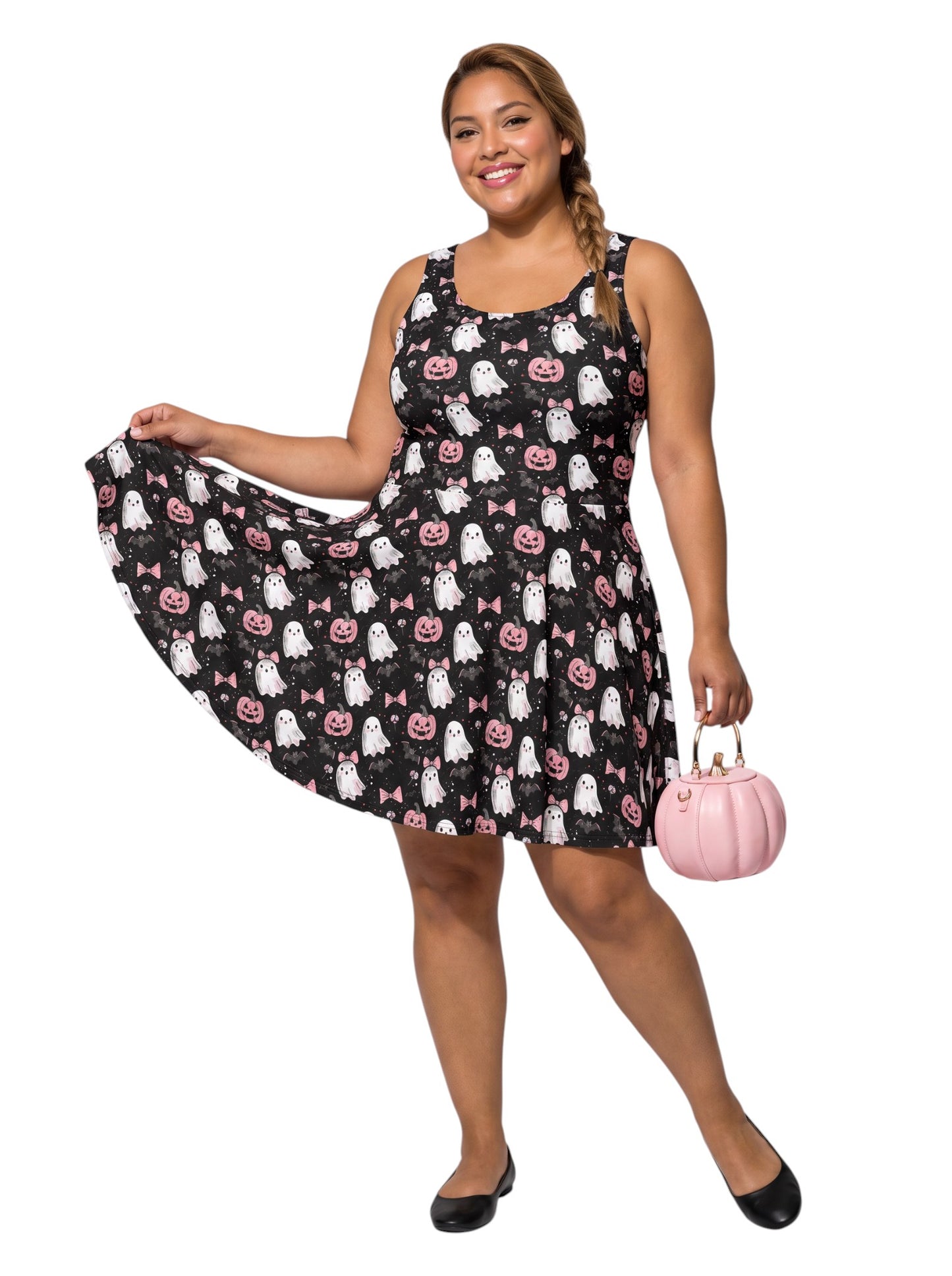 Plus size model wearing a pastel goth ghost skater dress featuring a cute pink bow and pumpkin pattern with a retro fit and flare silhouette.