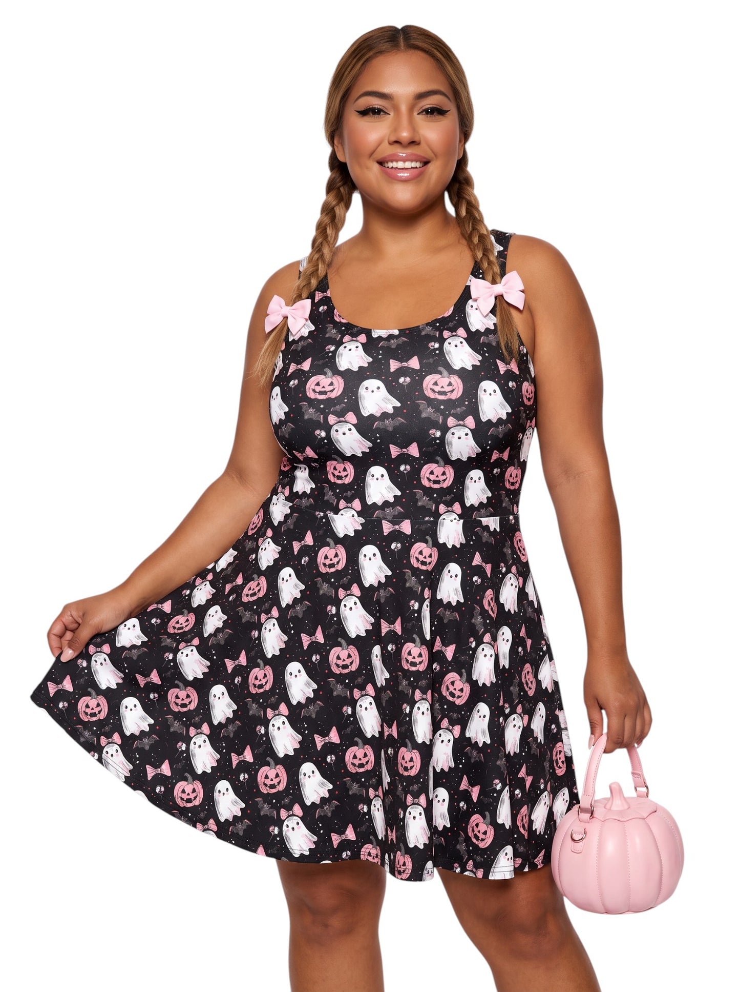 Plus size model wearing a pastel goth ghost skater dress featuring a cute pink bow and pumpkin pattern with a retro fit and flare silhouette.