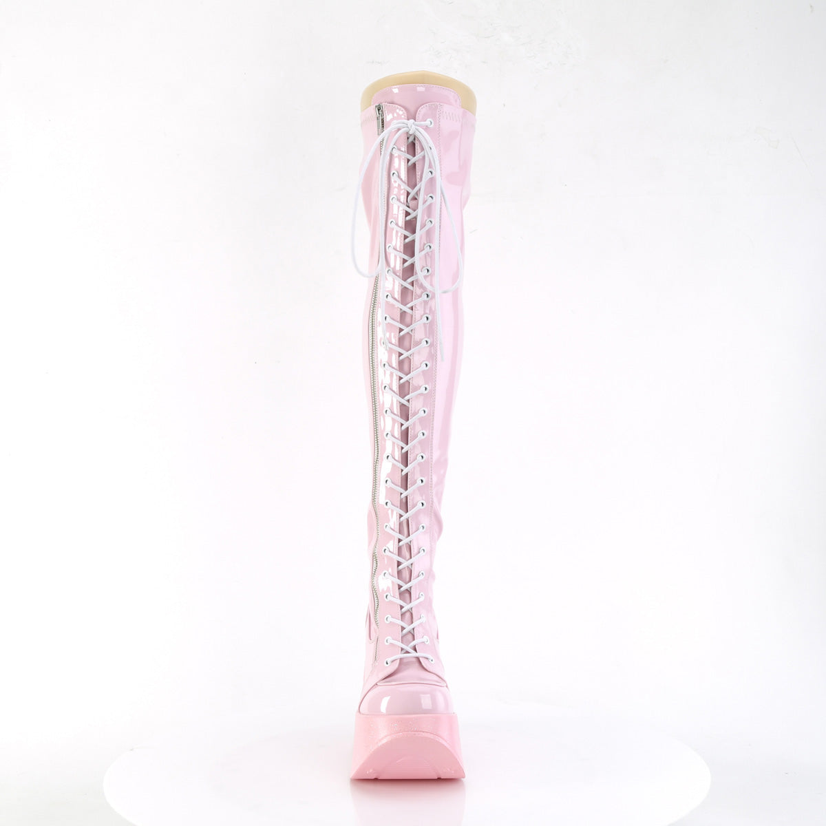 Pink holographic thigh-high platform wedge boots with star cutout and lace-up front