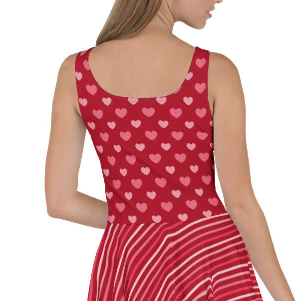 Red dress with heart pattern worn by a model on a white background