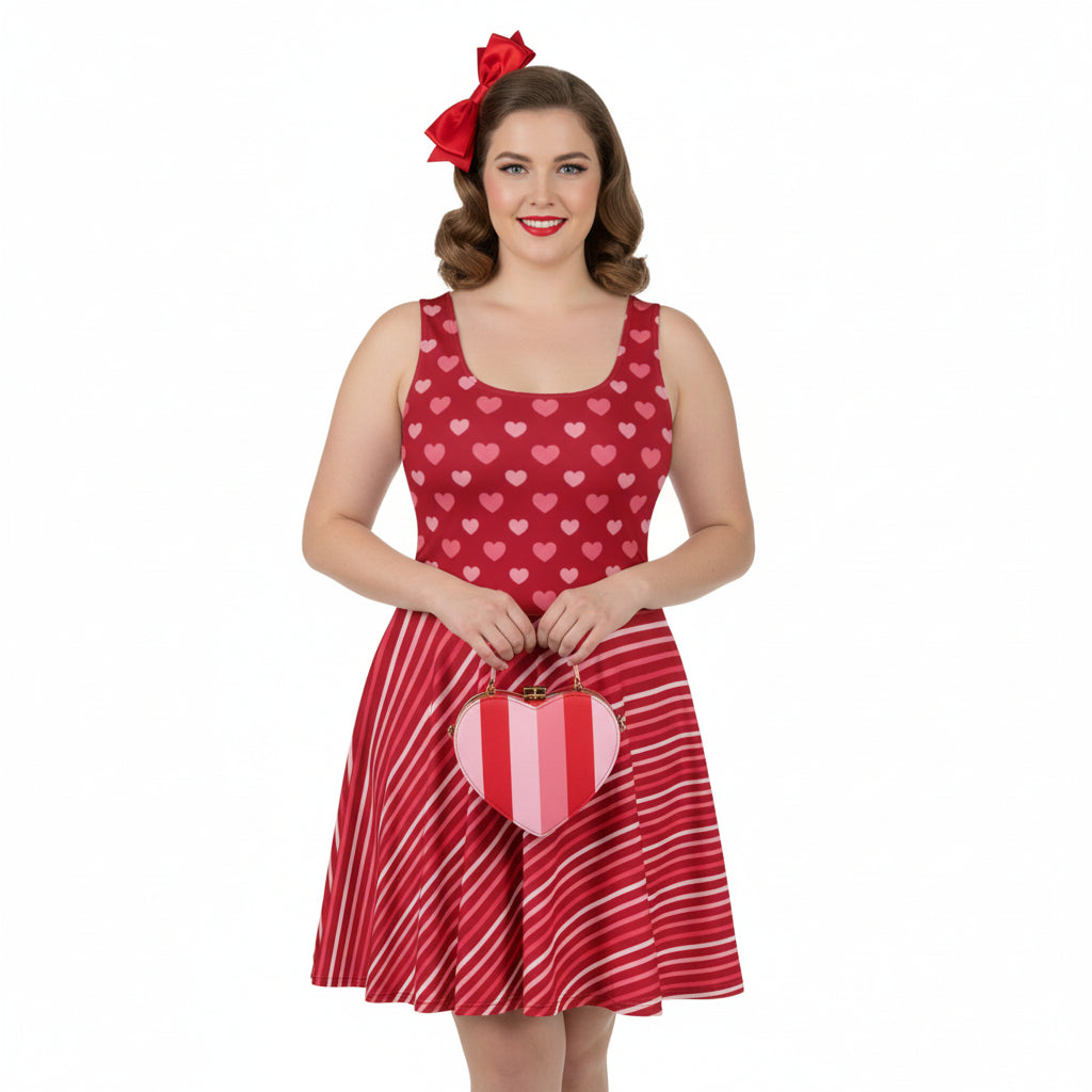 Woman wearing a red dress with heart pattern and holding a heart-shaped bag on a white background