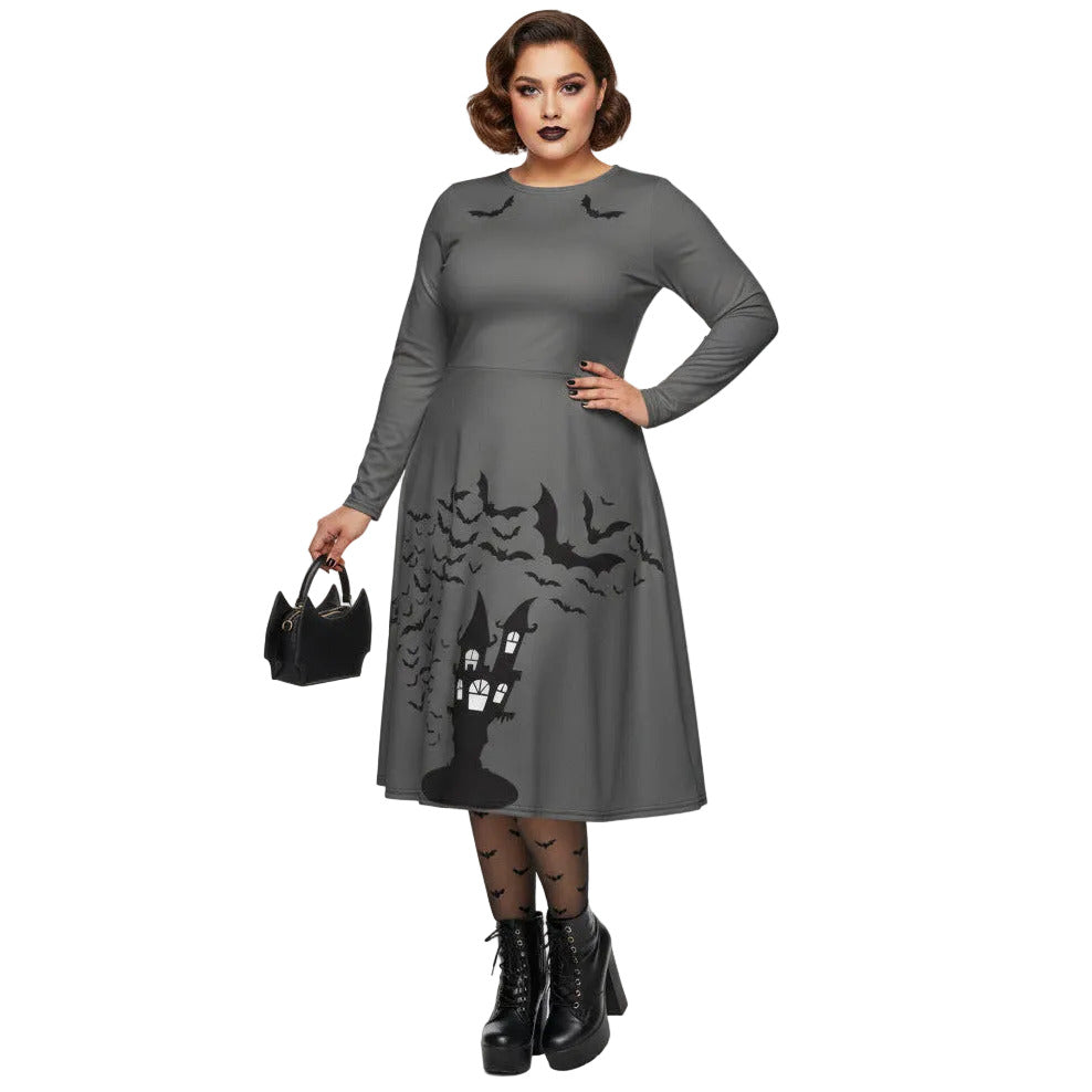 Plus size woman wearing a grey long sleeve goth pinup dress with black bat and haunted house print featuring functional side pockets.