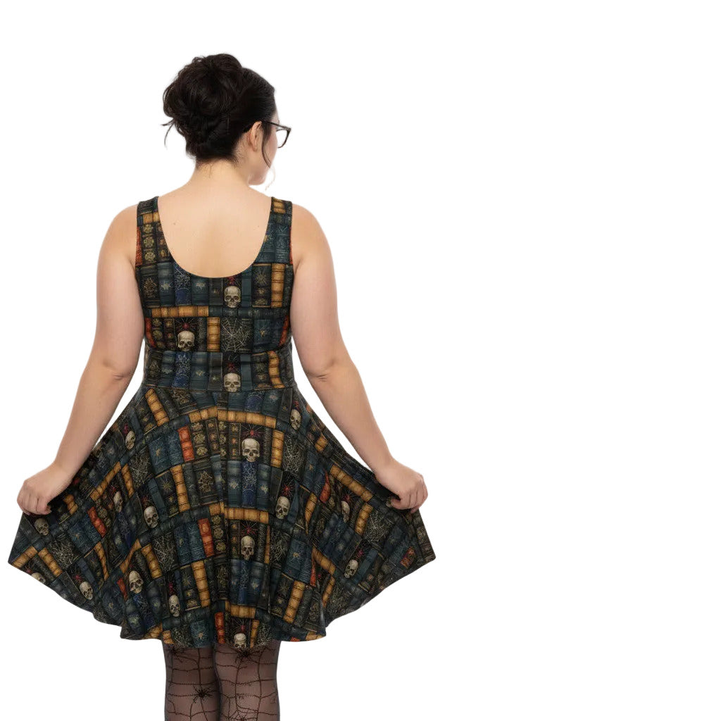 Woman wearing a dark academia skater dress with a vintage bookshelf and skull print.
