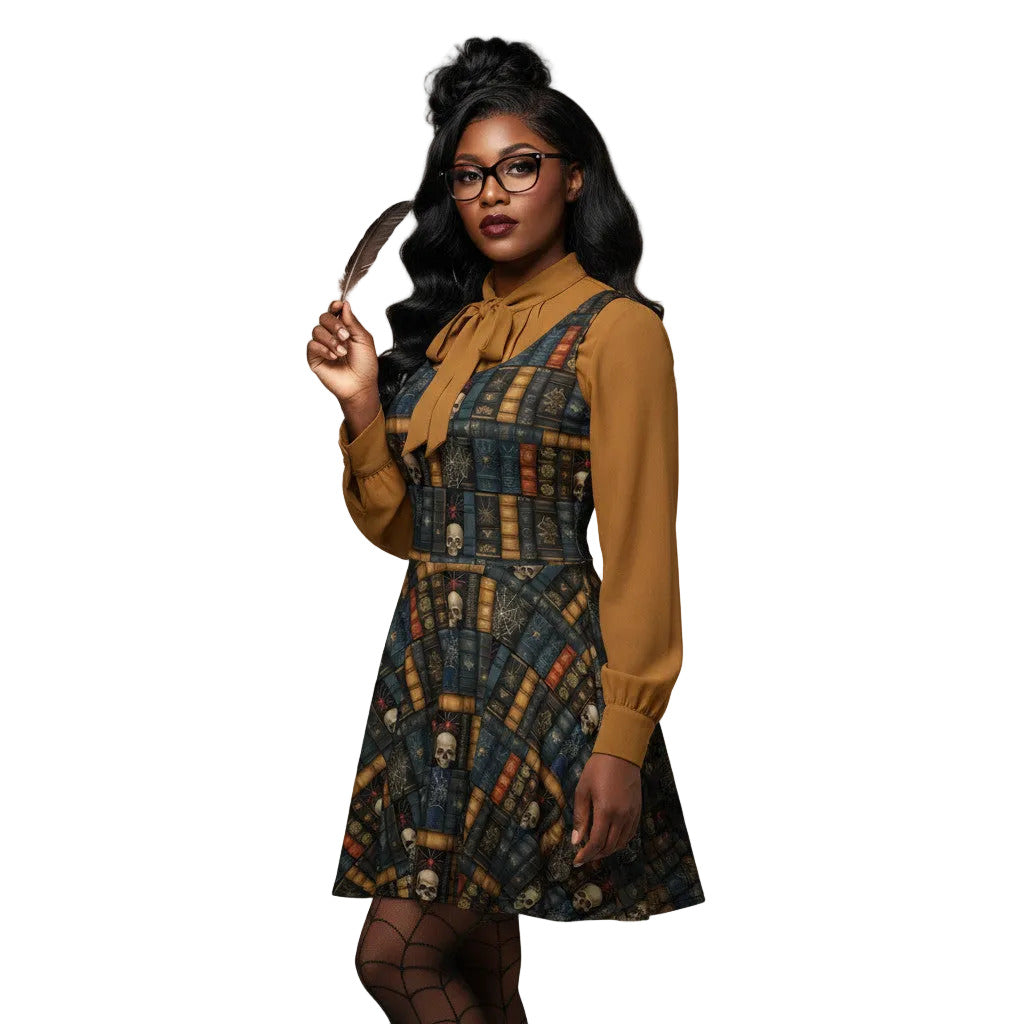 Woman wearing a dark academia skater dress with a vintage bookshelf and skull print, styled with a mustard yellow pussybow blouse and glasses.