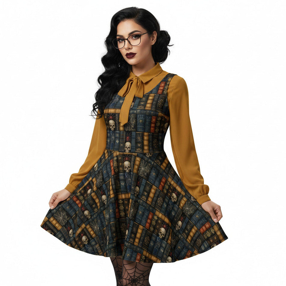 Woman wearing a dark academia skater dress with a vintage bookshelf and skull print, styled with a mustard yellow pussybow blouse and glasses.