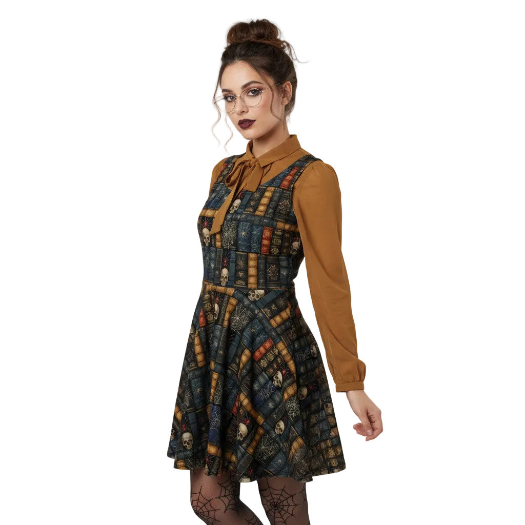 Woman wearing a dark academia skater dress with a vintage bookshelf and skull print, styled with a golden bronze pussybow blouse and glasses.