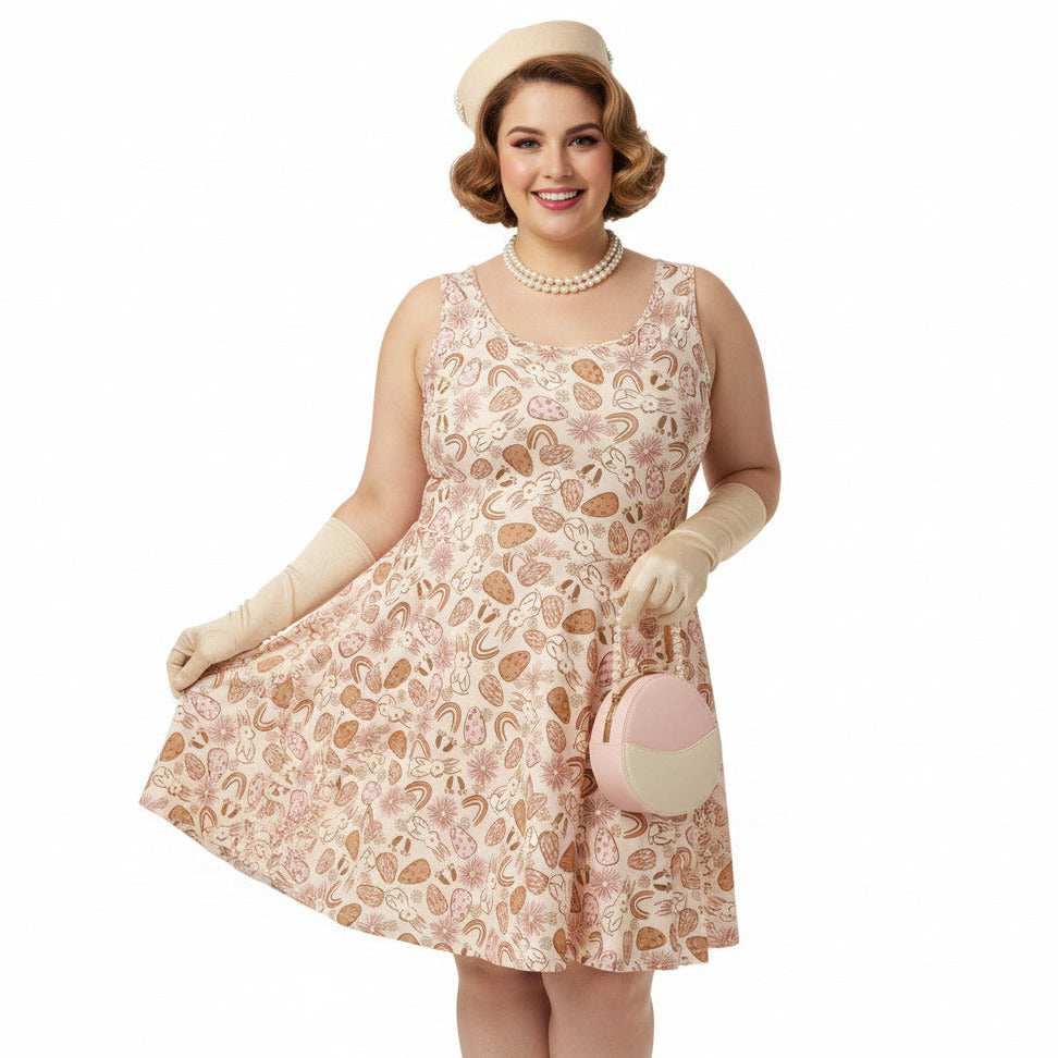 Plus size woman wearing a 1950s vintage style swing dress with pink and tan Easter egg and bunny print, featuring a sleeveless scoop neck and flared skirt.