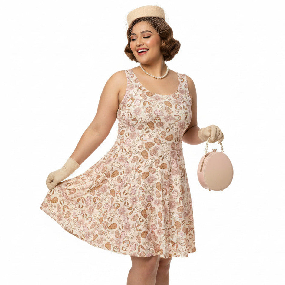 Plus size woman wearing a 1950s vintage style swing dress with pink and tan Easter egg and bunny print, featuring a sleeveless scoop neck and flared skirt.