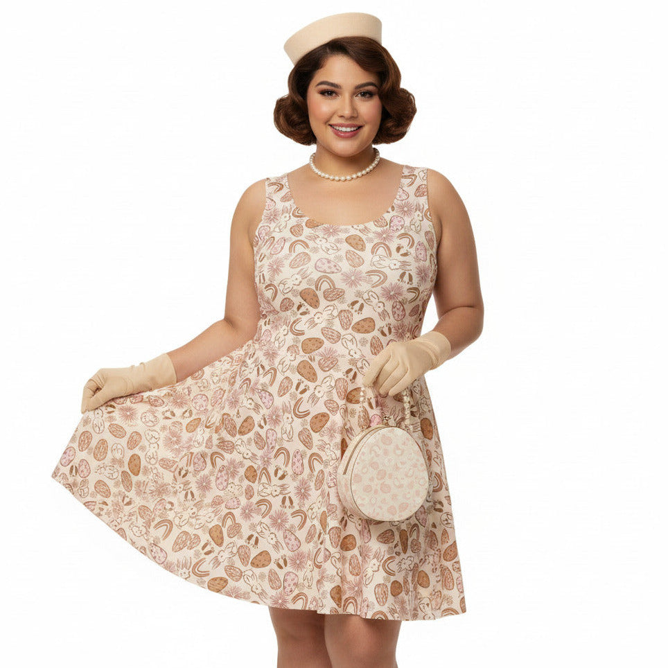 Plus size woman wearing a 1950s vintage style swing dress with pink and tan Easter egg and bunny print, featuring a sleeveless scoop neck and flared skirt.