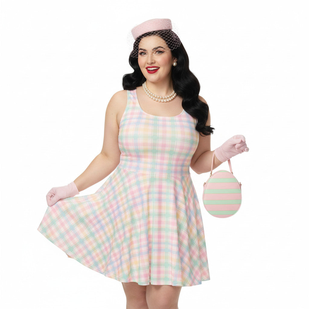 Plus size woman wearing a pastel pink and green gingham 1950s vintage style swing dress with matching pillbox hat and gloves.