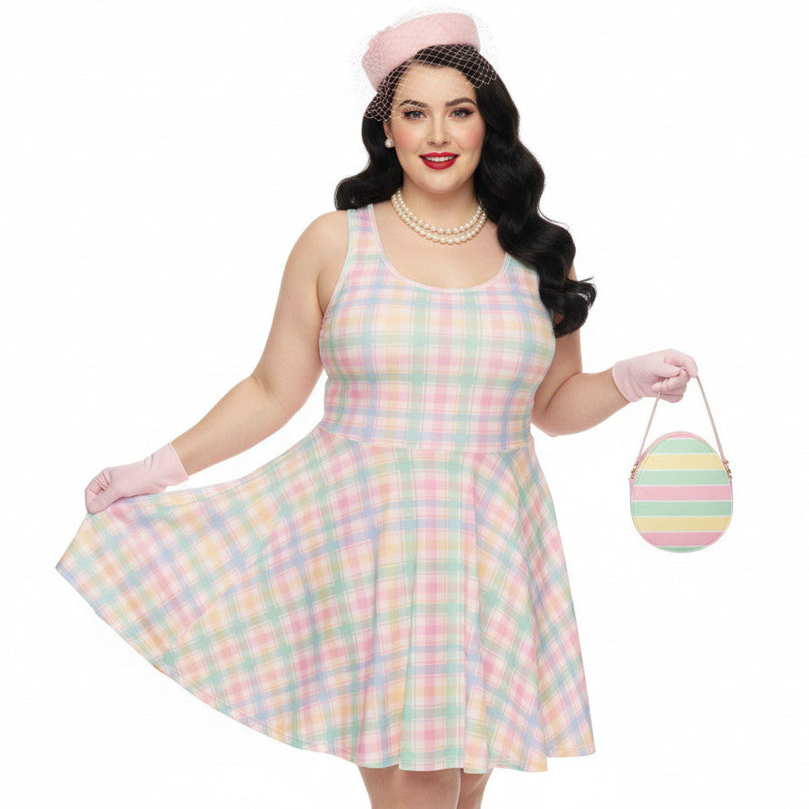 Plus size woman wearing a pastel pink and green gingham 1950s vintage style swing dress with matching pillbox hat and gloves.