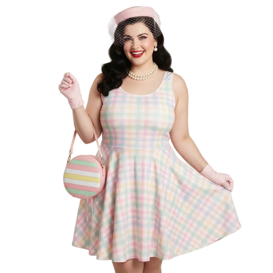 Plus size woman wearing a pastel pink and green gingham 1950s vintage style swing dress with matching pillbox hat.