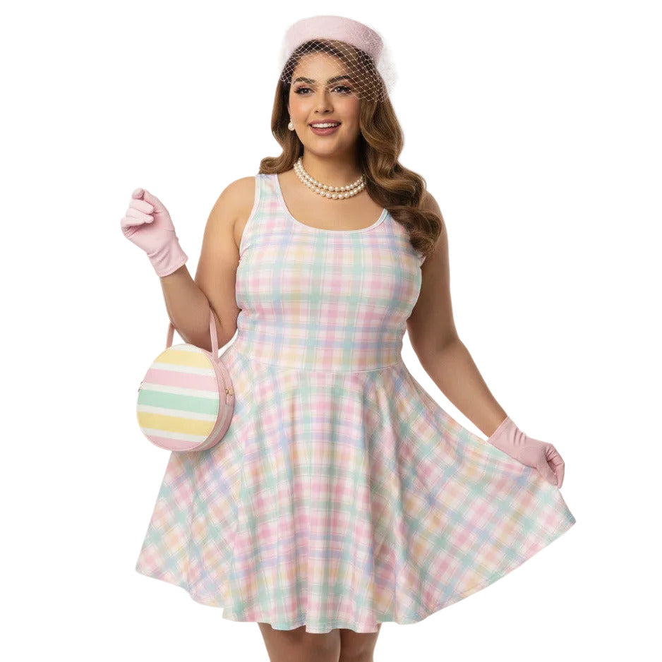 Plus size woman wearing a pastel pink and green gingham 1950s vintage style swing dress with matching pillbox hat.