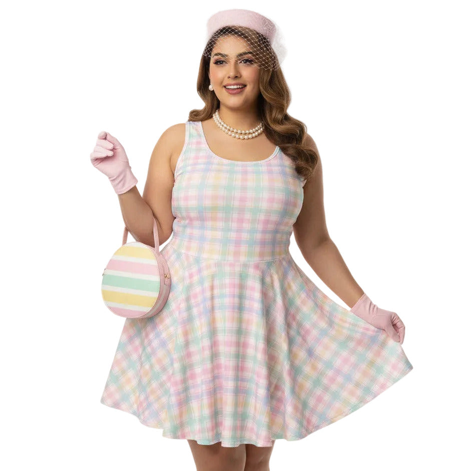 Plus size woman wearing a pastel pink and green gingham 1950s vintage style swing dress with matching pillbox hat.