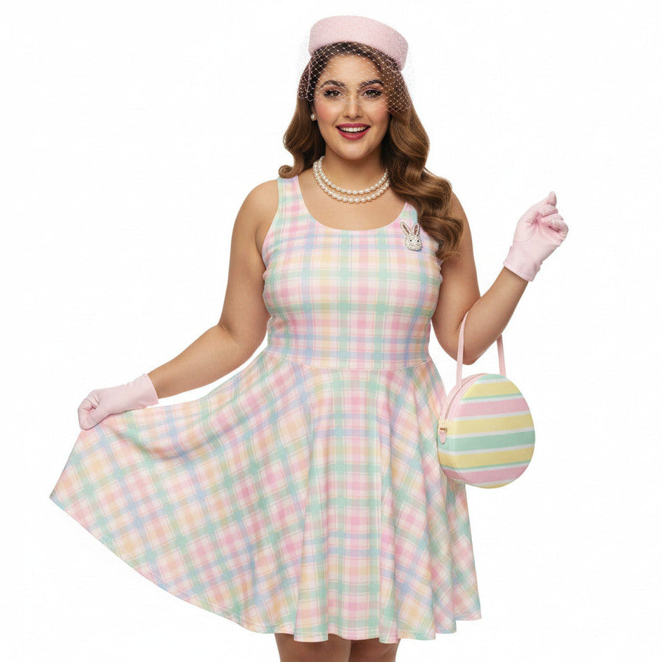 Plus size woman wearing a pastel pink and green gingham 1950s vintage style swing dress with matching pillbox hat.