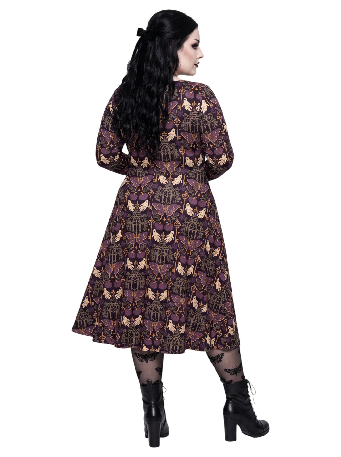 Plus size woman wearing a purple Whimsigoth gothic moth pattern long sleeve dress with pockets