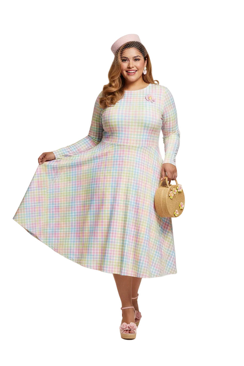Plus size woman wearing a pastel rainbow gingham long sleeve vintage swing dress with a boat neckline and pockets.