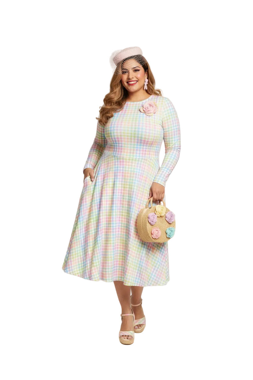 Plus size woman wearing a pastel rainbow gingham long sleeve vintage swing dress with a boat neckline and pockets.