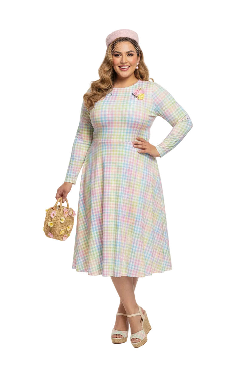 Plus size woman wearing a pastel rainbow gingham long sleeve vintage swing dress with a boat neckline and pockets.