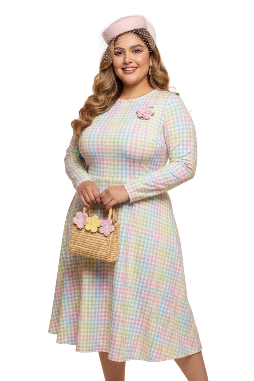Plus size woman wearing a pastel rainbow gingham long sleeve vintage swing dress with a boat neckline and pockets.