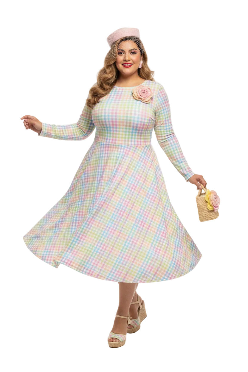 Plus size woman wearing a pastel rainbow gingham long sleeve vintage swing dress with a boat neckline and pockets.