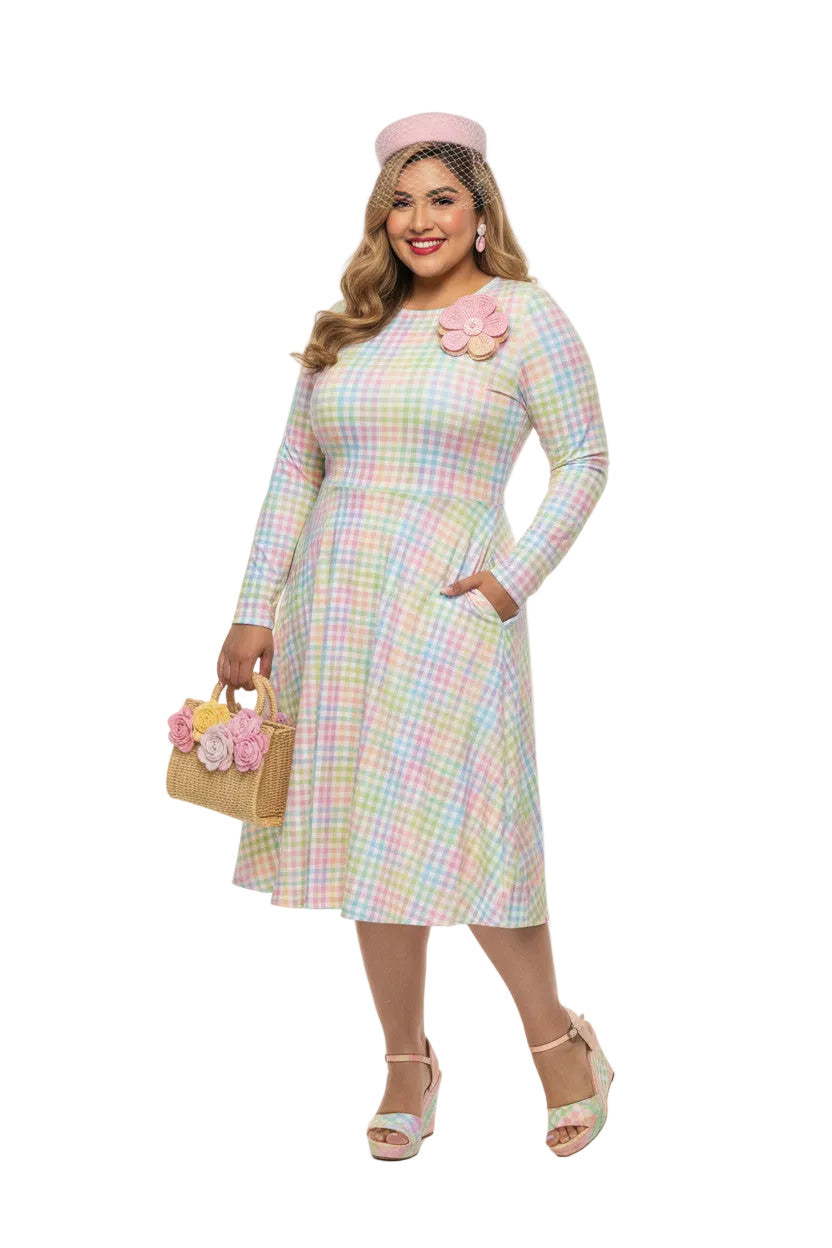 Plus size woman wearing a pastel rainbow gingham long sleeve vintage swing dress with a boat neckline and pockets.