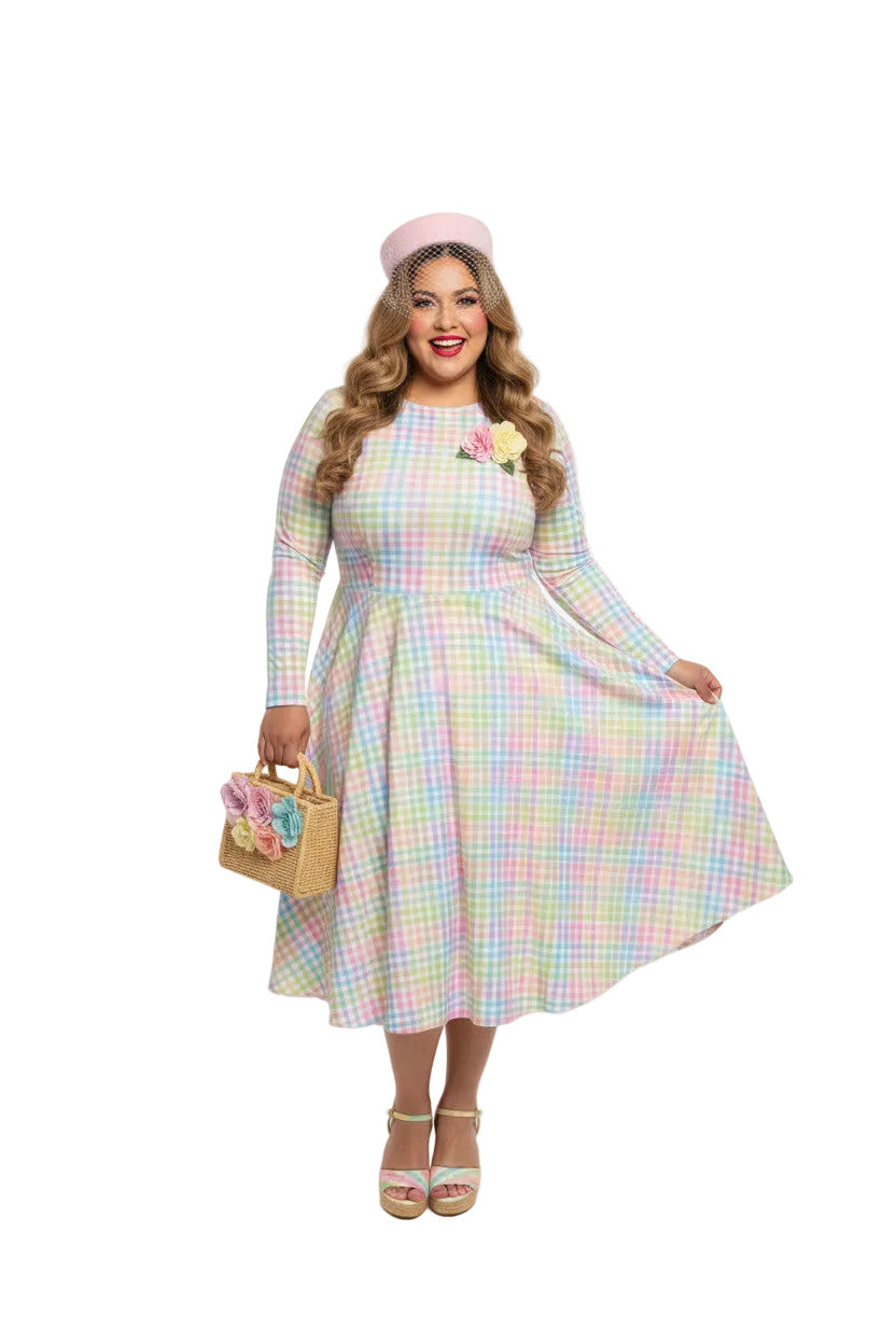 Plus size woman wearing a pastel rainbow gingham long sleeve vintage swing dress with a boat neckline and pockets.