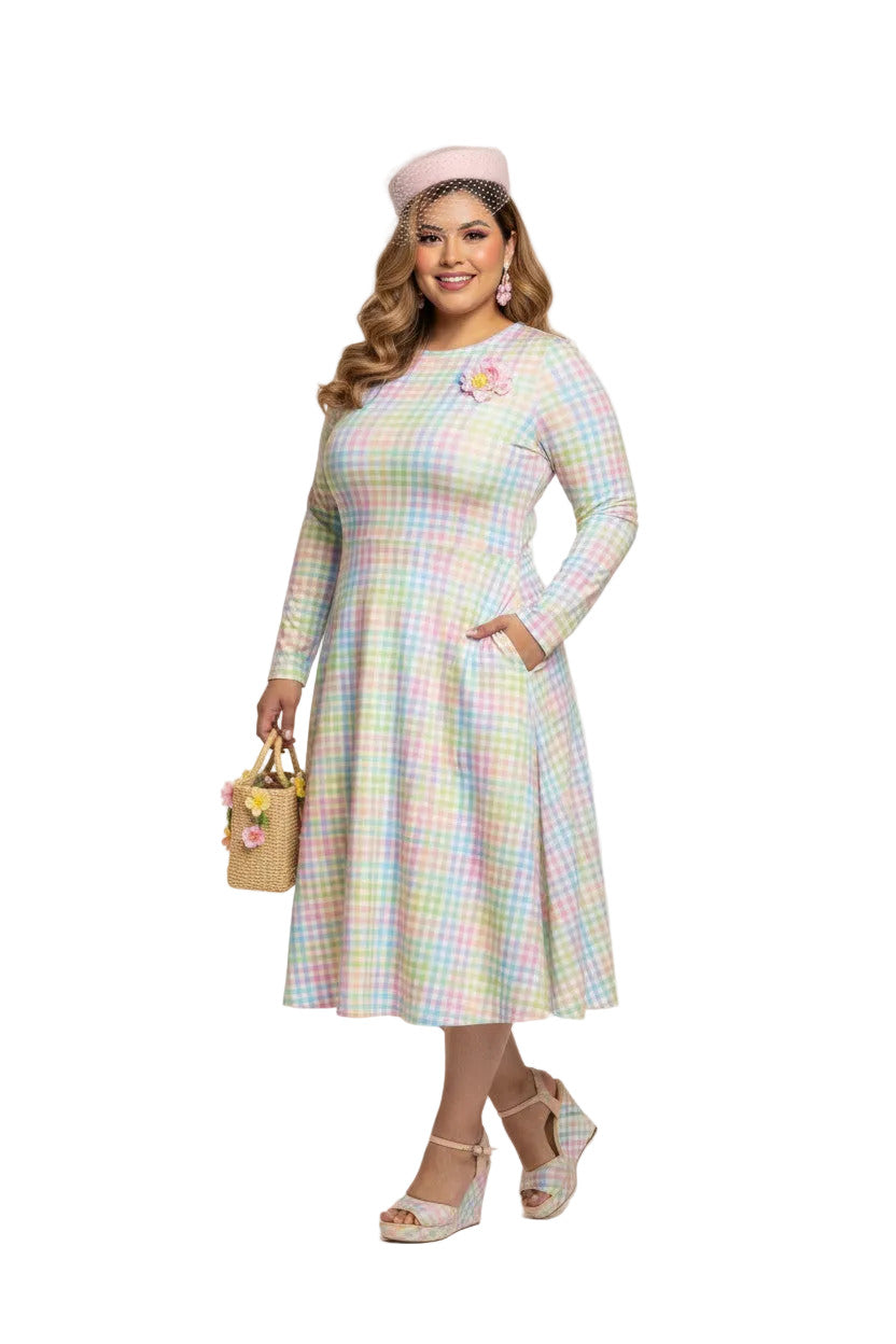 Plus size woman wearing a pastel rainbow gingham long sleeve vintage swing dress with a boat neckline and pockets.