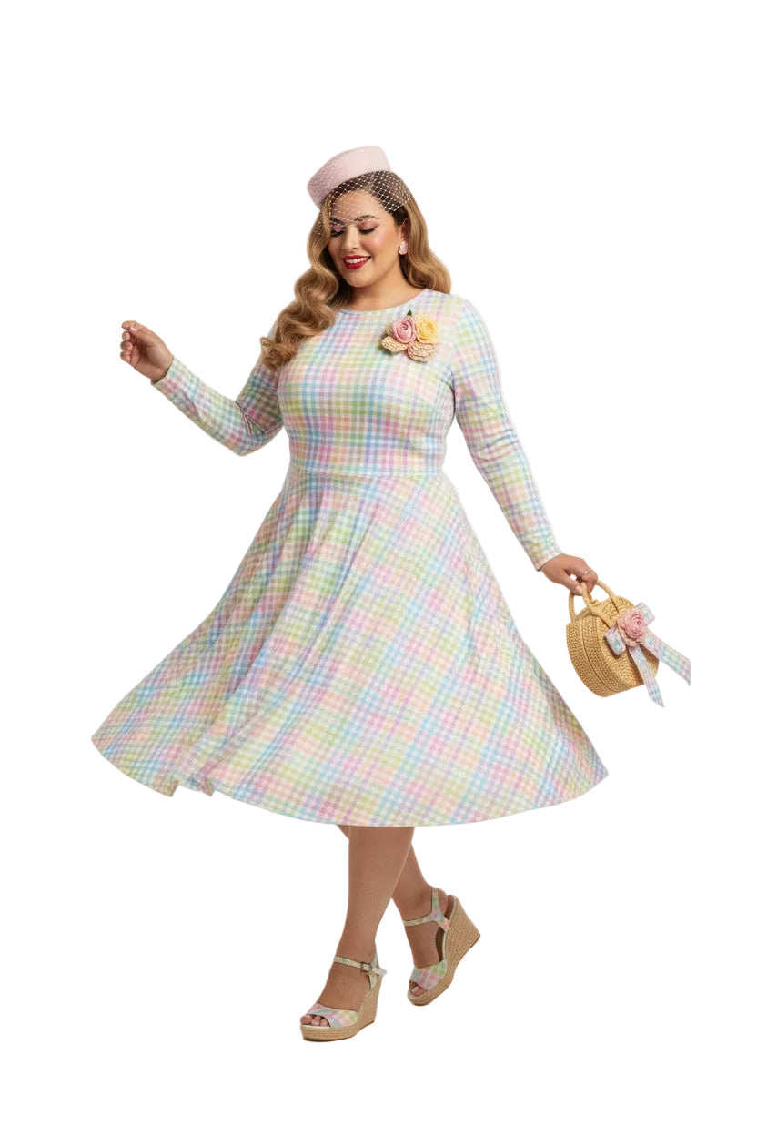 Plus size woman wearing a pastel rainbow gingham long sleeve vintage swing dress with a boat neckline and pockets.