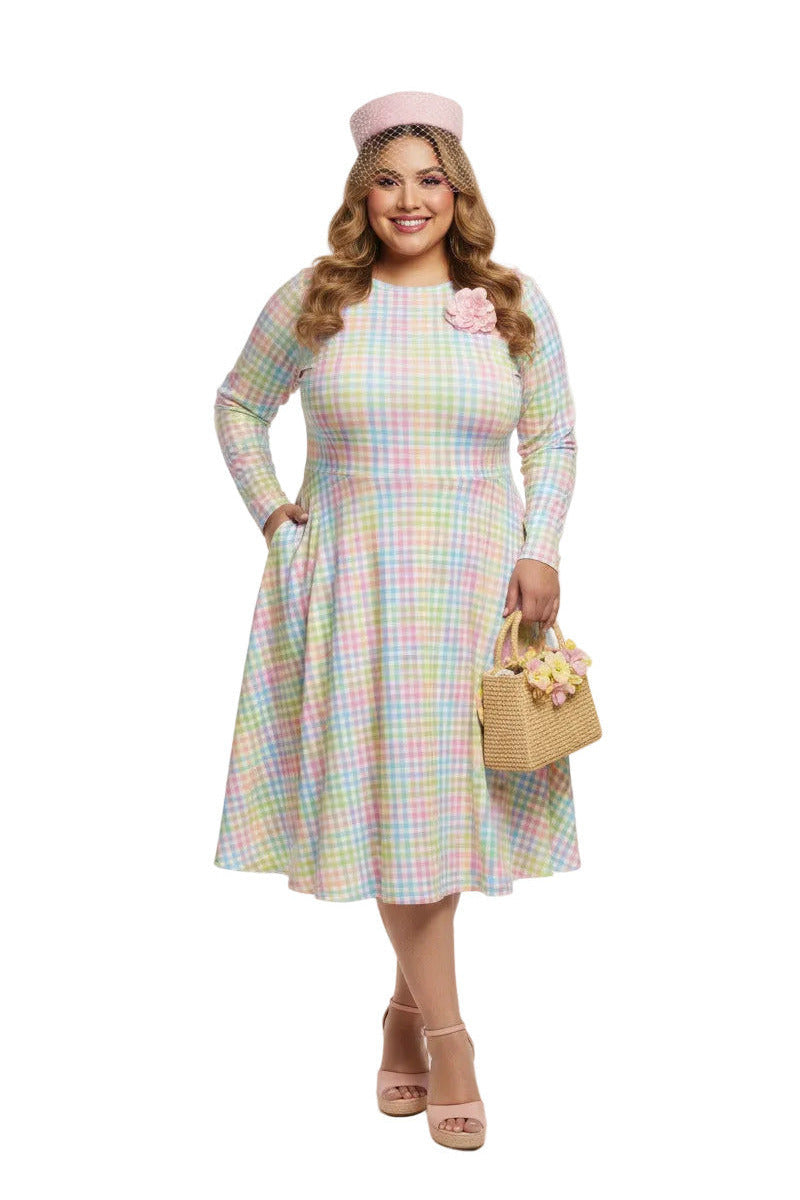 Plus size woman wearing a pastel rainbow gingham long sleeve vintage swing dress with a boat neckline and pockets.
