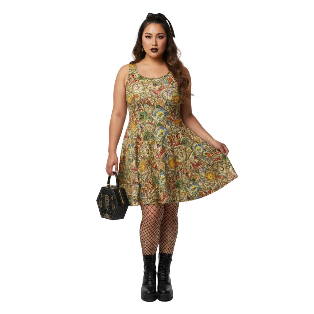 Woman wearing a Whimsigoth tarot card print skater dress with fishnets and a gothic handbag.