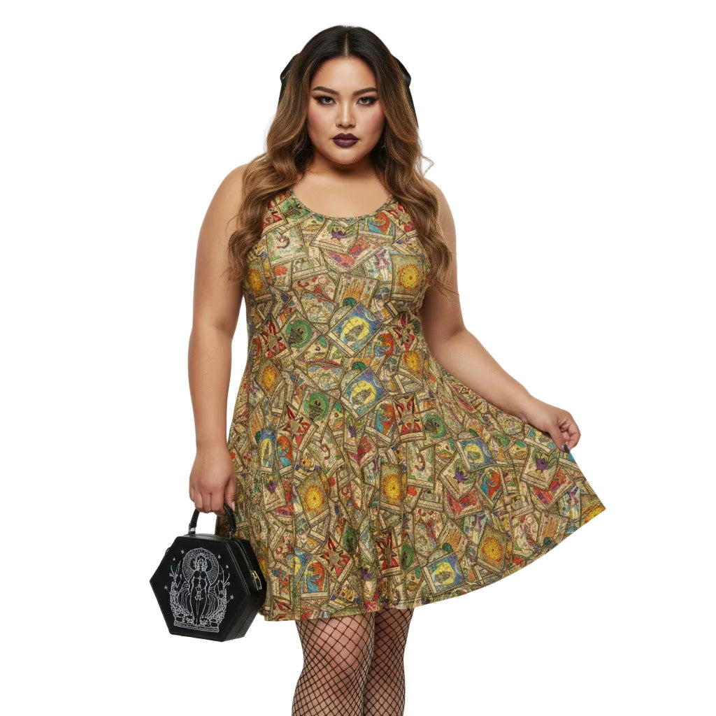 Plus size woman wearing a Whimsigoth tarot card print skater dress with fishnets and a gothic handbag.