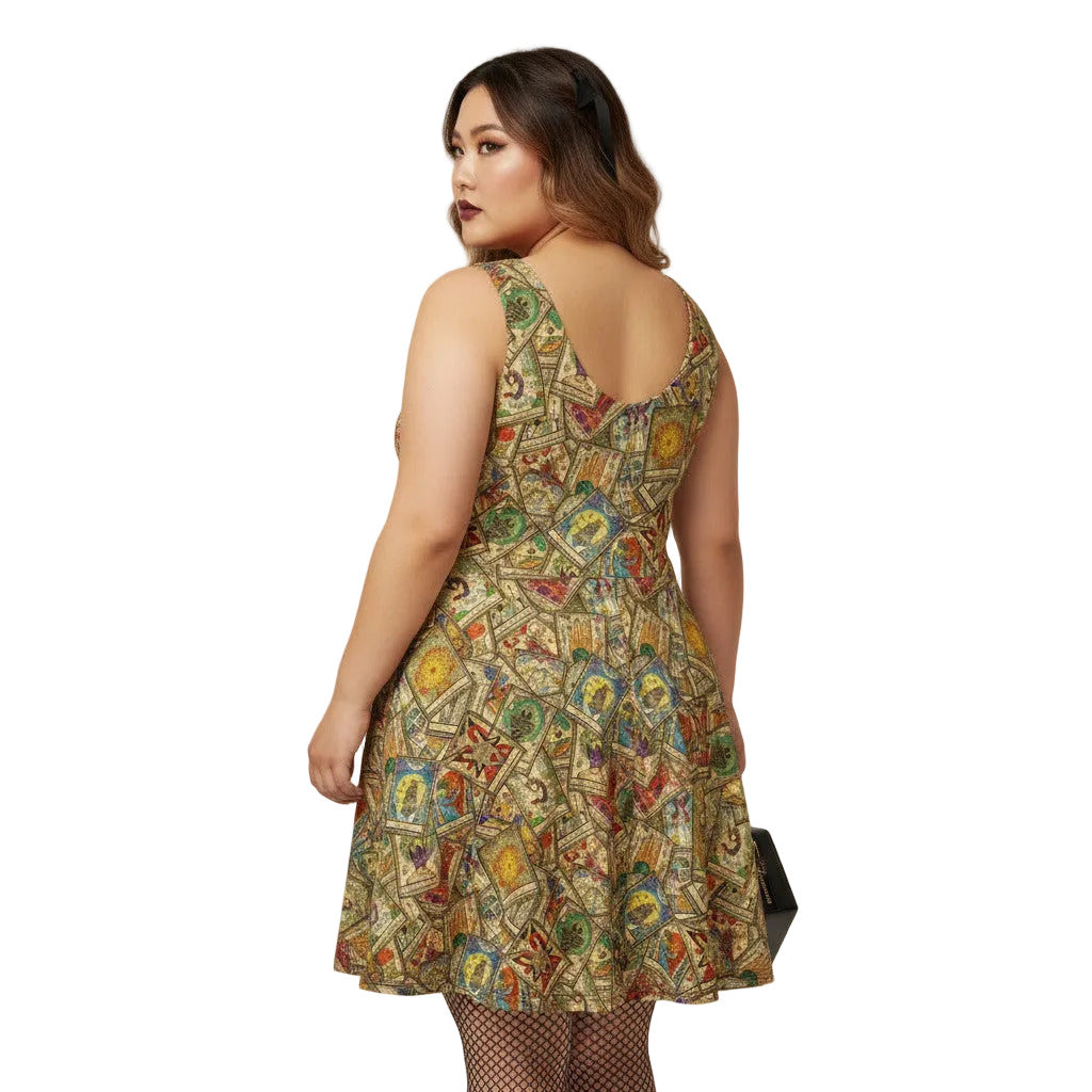 Plus size woman wearing a Whimsigoth tarot card print skater dress with fishnets and a gothic handbag.