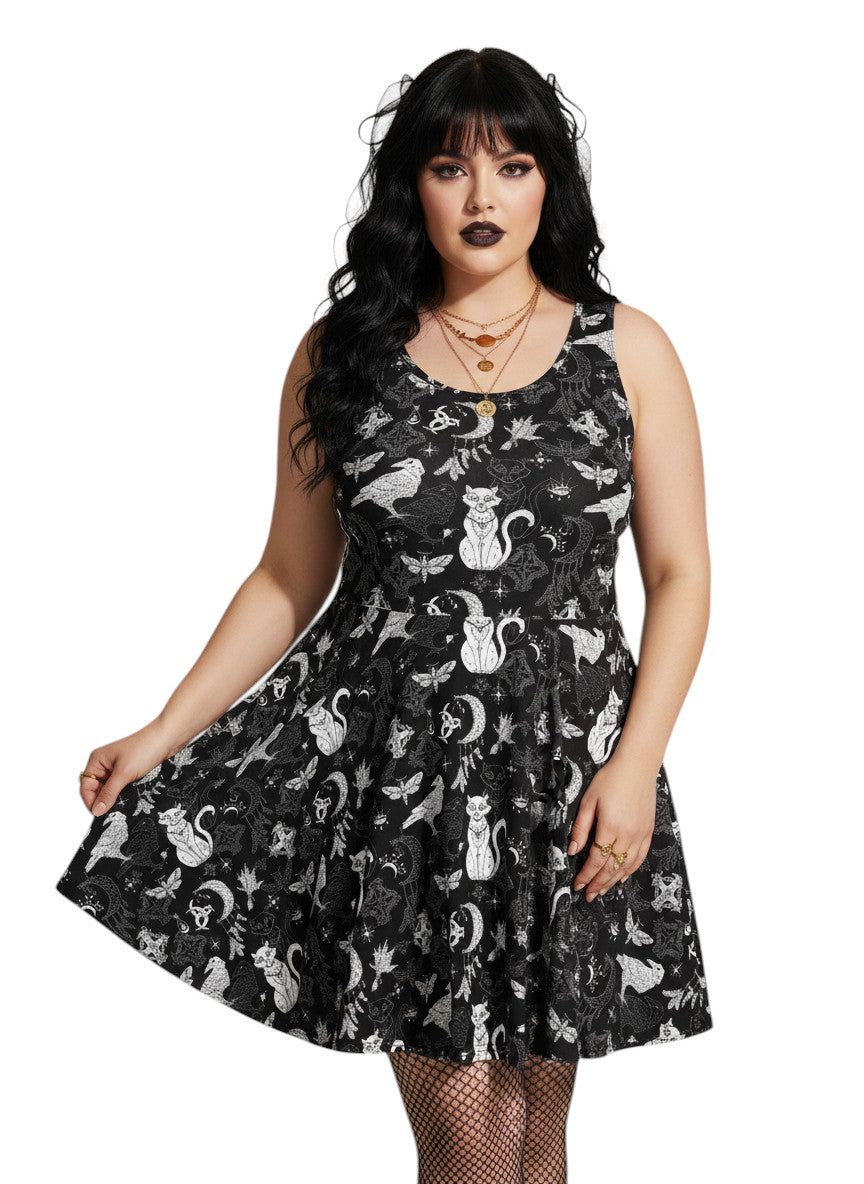 Plus size woman wearing a Whimsigoth fit and flare dress with witchy cat and celestial moon prints.